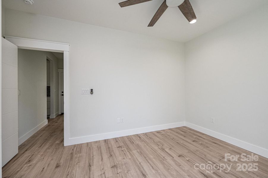 Main Level #2 Bedroom with ceiling fan and walk in closet Main Level #2 Bedroom with ceiling fan and walk in closet