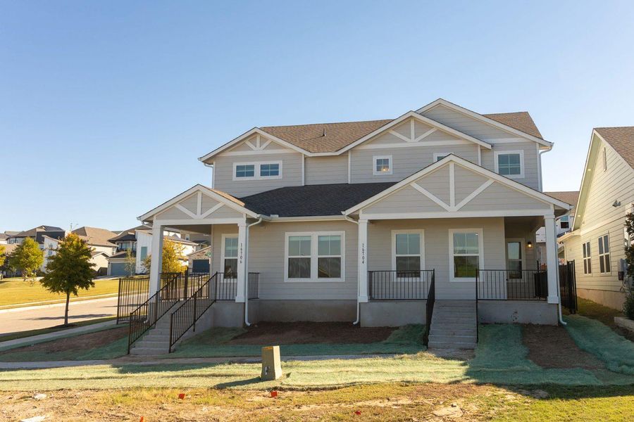 View of front of property featuring a porch, a shingled roof, and a front lawn View of front of property featuring a porch, a shingled roof, and a front lawn