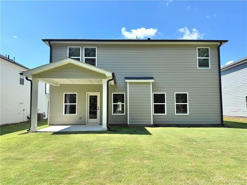 Front exterior of a new home in , Braselton, GA, highlighting curb appeal (Image 1).
