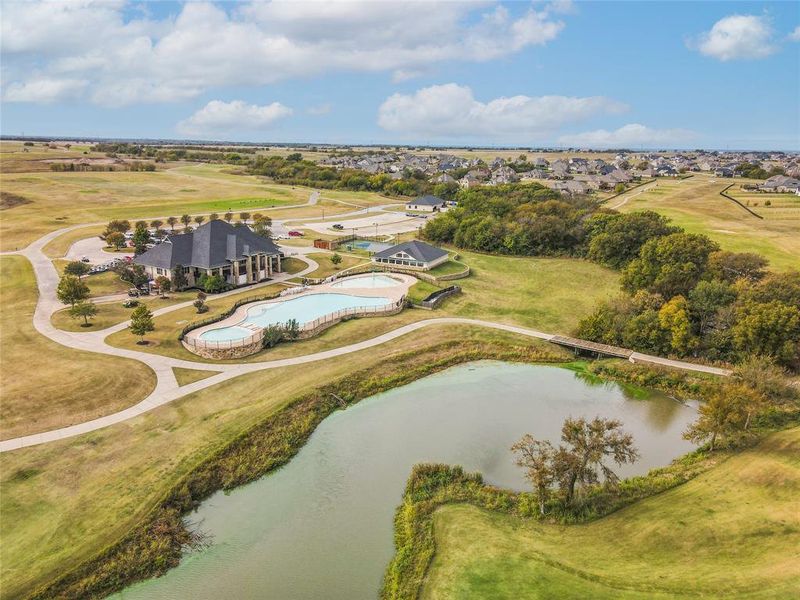 Birds eye view of property with a water view