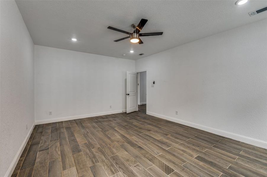 Spare room featuring dark wood finished floors, recessed lighting, and ceiling fan Spare room featuring dark wood finished floors, recessed lighting, and ceiling fan