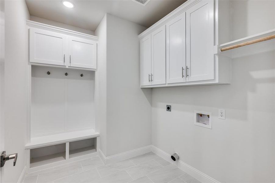 Laundry room featuring washer hookup, cabinets, electric dryer hookup, and light tile patterned floors