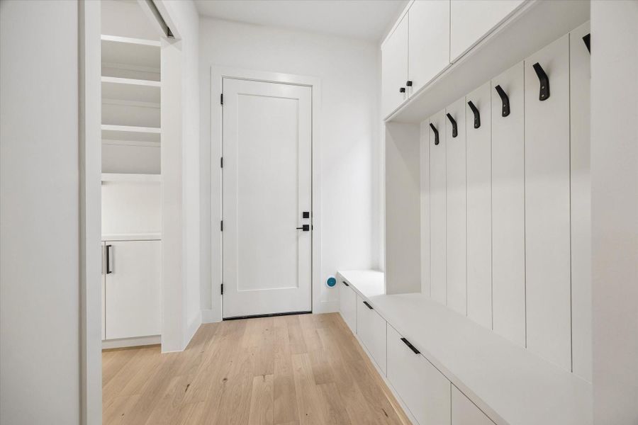 The hall in from the garage has mud room built-ins and the walk in pantry to the left.