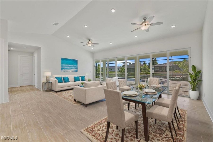 Dining area featuring lofted ceiling, recessed lighting, a ceiling fan, and wood tiled floors