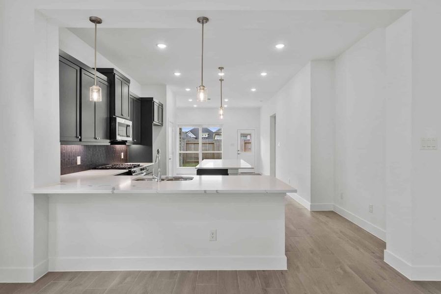 Representative furnished interior of a home built from the Carlisle by Chesmar Homes in Sunterra, Katy (Image 5).