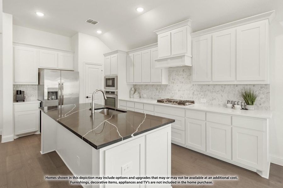 Kitchen with white cabinets, dark quartz island, tile backsplash, and stainless steel appliances on hardwood floors Kitchen with white cabinets, dark quartz island, tile backsplash, and stainless steel appliances on hardwood floors