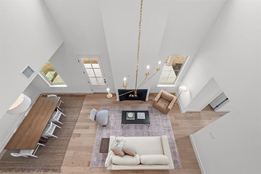 Living room with a towering ceiling and wood-type flooring