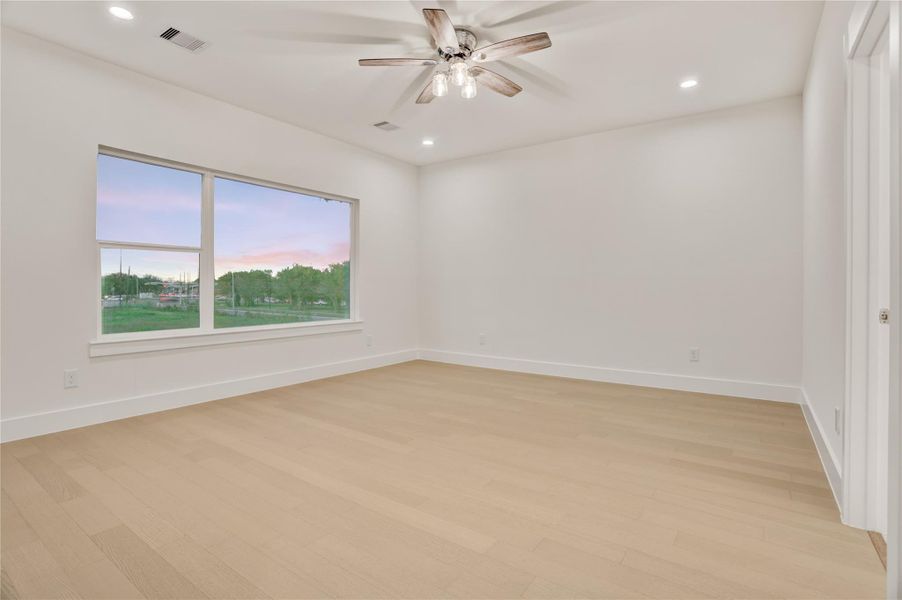 Spacious primary suite with wide picture window and bright, airy ambiance.