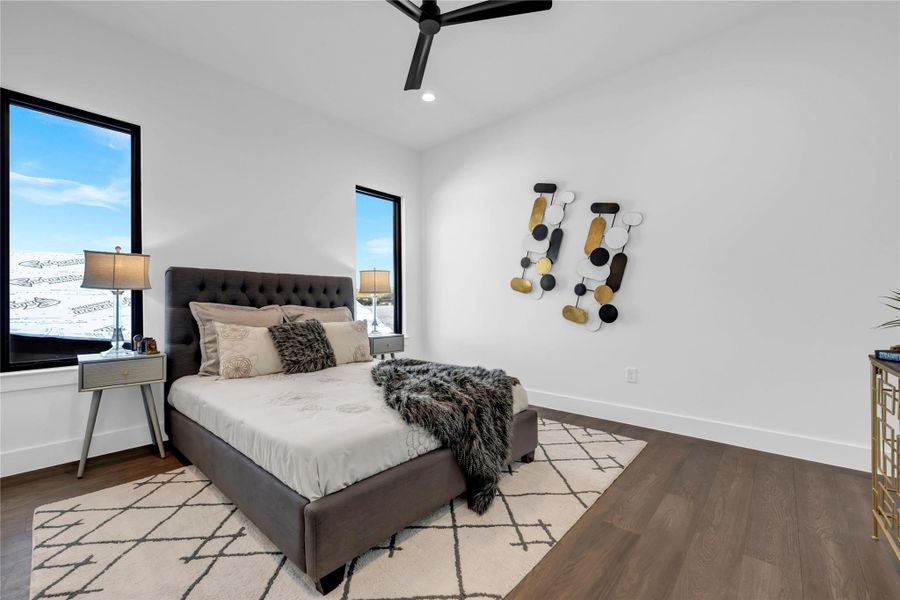 Bedroom with dark wood-style floors, recessed lighting, and ceiling fan