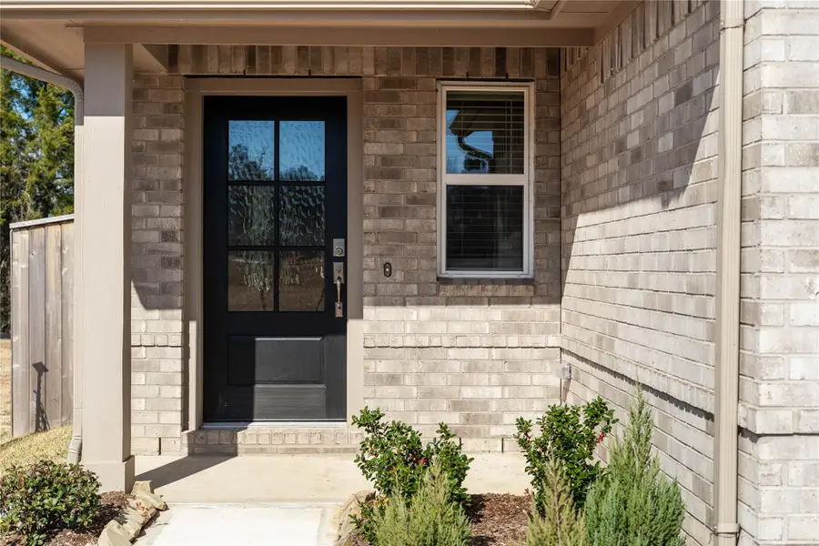 This home is modern elegance with a timeless brick exterior and high quality entry door.