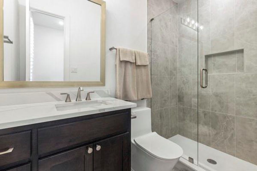 Bathroom featuring vanity and a stall shower Bathroom featuring vanity and a stall shower