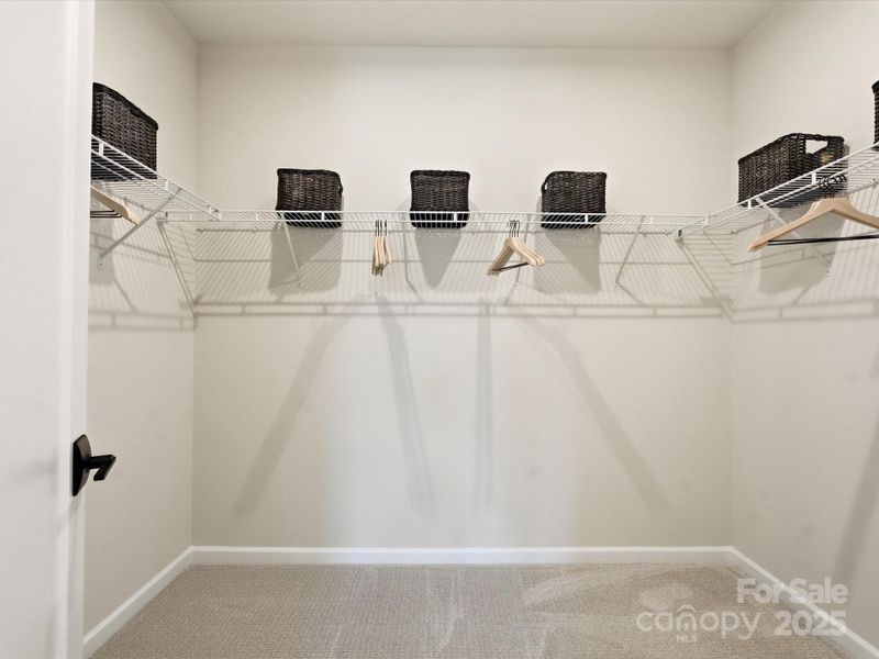 Generously Sized Primary Walk-In Closet. *Model Photos | Actual Finishes, Structural Selections, and Orientation May Vary. Generously Sized Primary Walk-In Closet. *Model Photos | Actual Finishes, Structural Selections, and Orientation May Vary.