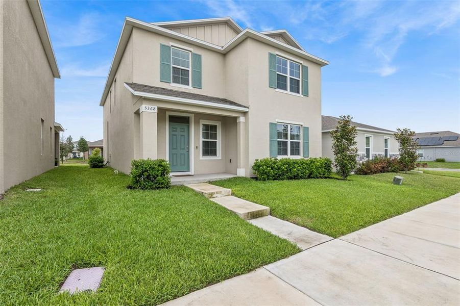 Front exterior of a new home in Windrose, Apopka, FL, highlighting curb appeal (Image 20).