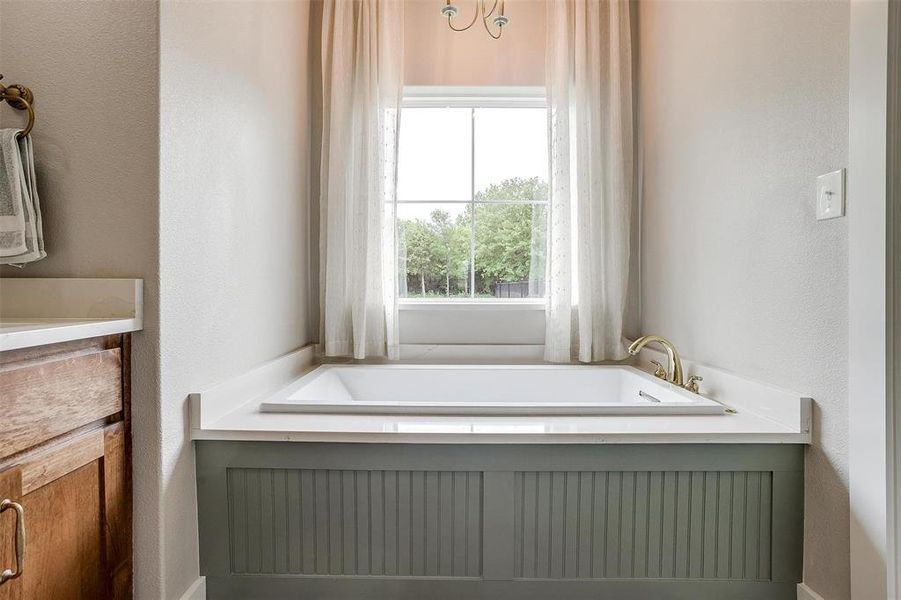 Primary bath with garden tub & chandelier. Primary bath with garden tub & chandelier.