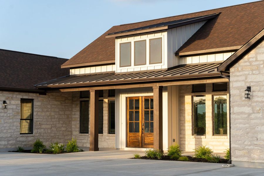 Doorway to property featuring a standing seam roof, board and batten siding, and a metal roof Doorway to property featuring a standing seam roof, board and batten siding, and a metal roof