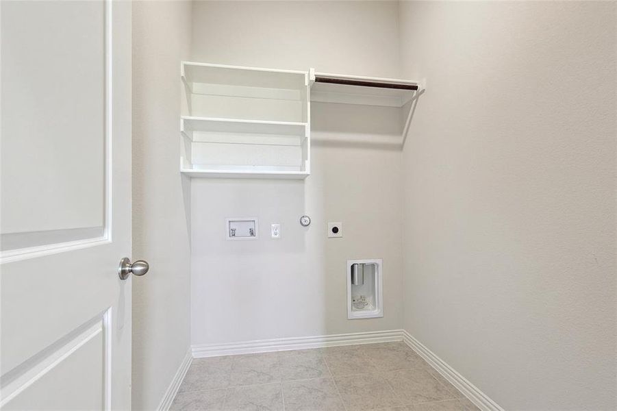 Laundry room featuring hookup for a washing machine, electric dryer hookup, light tile patterned floors, and hookup for a gas dryer