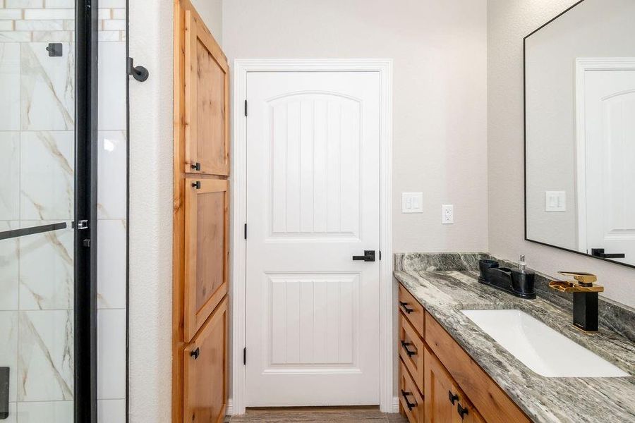 Bathroom with vanity and a shower with shower door