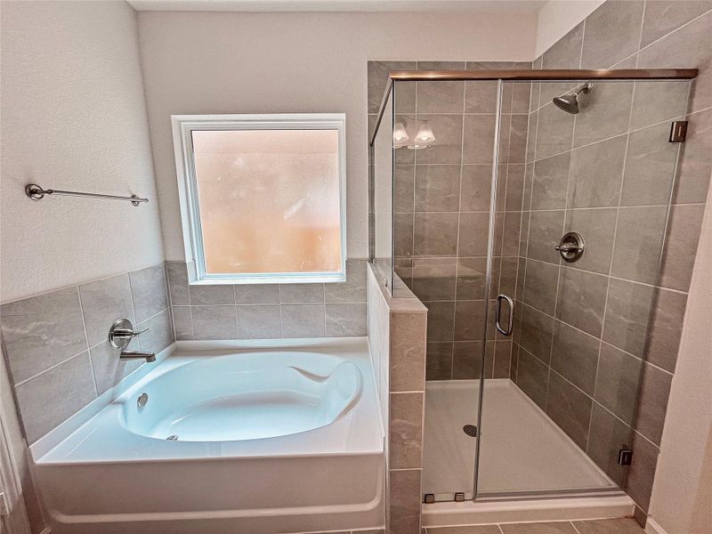 The Princeton II- Primary Bathroom with Separate Garden Tub and Walk-in Shower. Home under construction, image used for illustrative purposes only, colors and options will vary. The Princeton II- Primary Bathroom with Separate Garden Tub and Walk-in Shower. Home under construction, image used for illustrative purposes only, colors and options will vary.