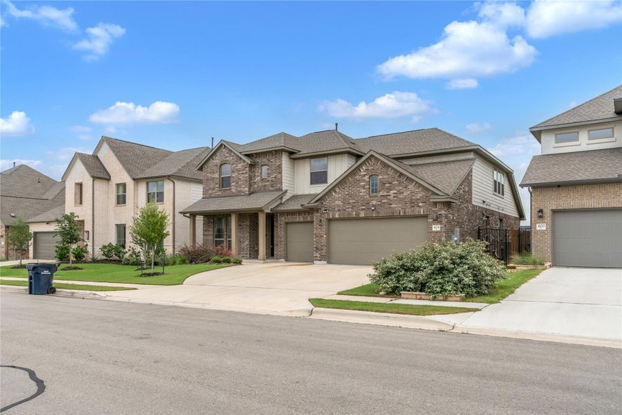 A well-maintained street view of this inviting two-story residence with a brick facade.