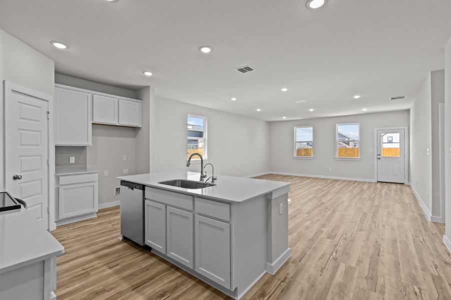 A kitchen with white cabinets.