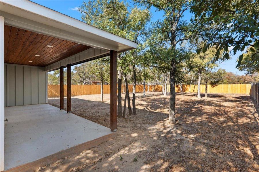 Fenced backyard with a patio area