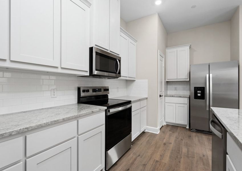 The kitchen has sprawling granite countertops.