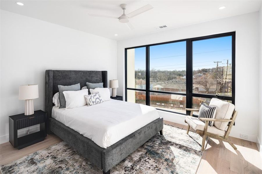 Bedroom with ceiling fan and light hardwood / wood-style flooring