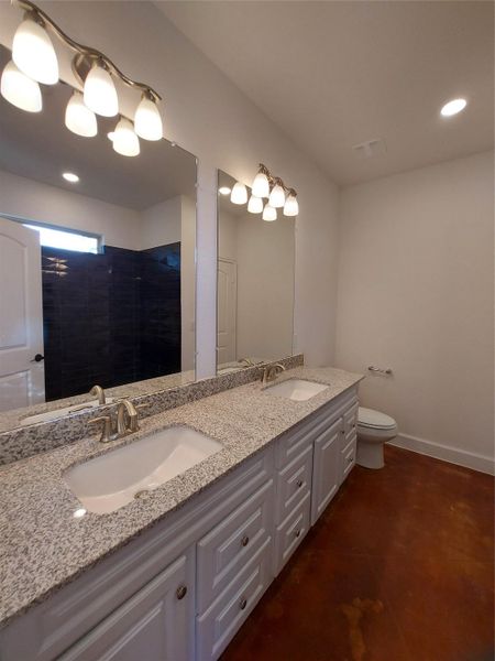Master Bathroom Featuring Light Stone Granite Double Vanity. The Master Bath also has it's own closet.