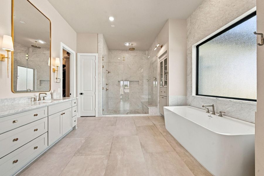 Start and end your day in style with a freestanding tub, a glass-enclosed shower with a built-in seat, and seamless access to the spacious primary walk-in closet.