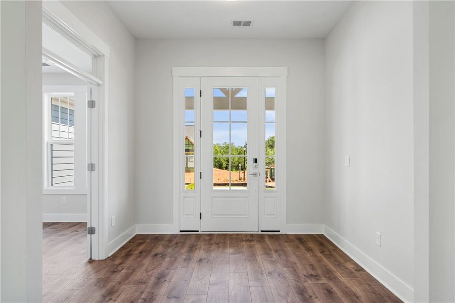 A welcoming entry features hardwood floors and a b
