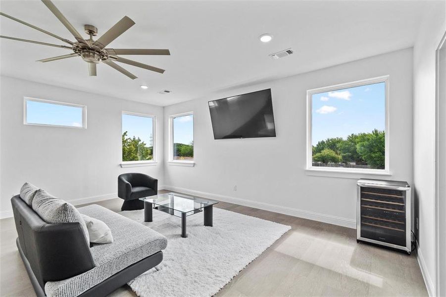 2nd floor Sitting room featuring wine cooler, light wood finished floors, recessed lighting, and ceiling fan