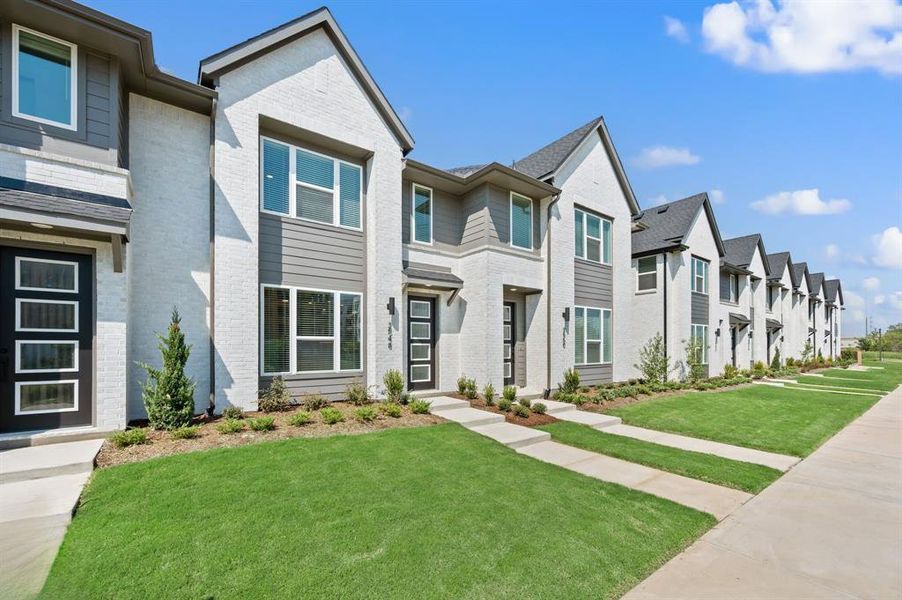 Beautiful white brick paired with contemporary trim colors create a dream home with wonderful curb appeal!