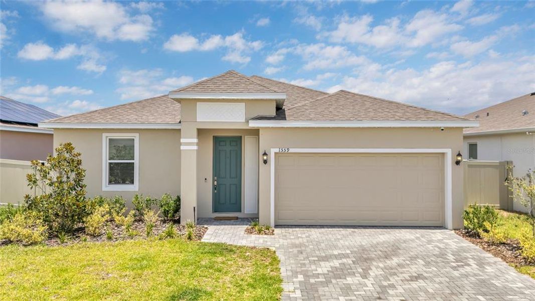Front exterior of a new home in Tarpon Bay, Haines City, FL, highlighting curb appeal (Image 2). Front exterior of a new home in Tarpon Bay, Haines City, FL, highlighting curb appeal (Image 2).
