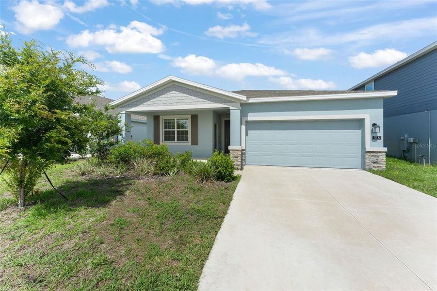 Front exterior of a new home in Peace Creek Reserve, Winter Haven, FL, highlighting curb appeal (Image 21).