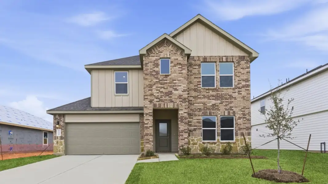 Front exterior of a new home in August Trails, Needville, TX, highlighting curb appeal (Image 1). Front exterior of a new home in August Trails, Needville, TX, highlighting curb appeal (Image 1).