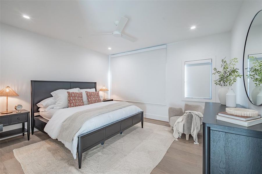 Bedroom with ceiling fan and light hardwood / wood-style floors