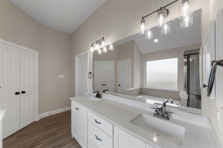 Dual vanity with integrated sinks, white cabinetry, and a light-toned countertop