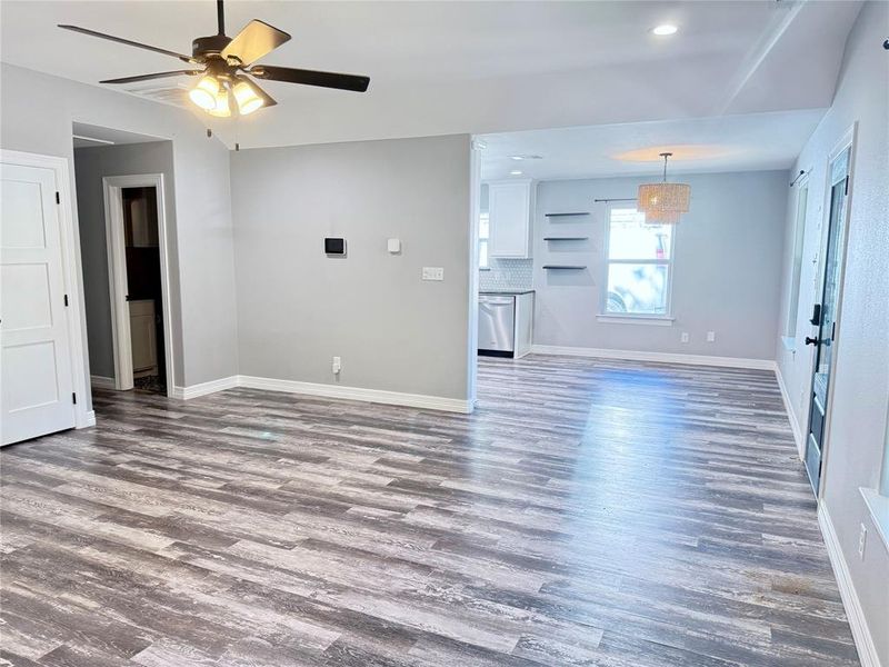 Unfurnished living room with wood finished floors, a ceiling fan, and recessed lighting Unfurnished living room with wood finished floors, a ceiling fan, and recessed lighting