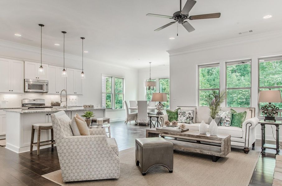 Living area featuring crown molding, dark wood finished floors, ceiling fan, and recessed lighting Living area featuring crown molding, dark wood finished floors, ceiling fan, and recessed lighting