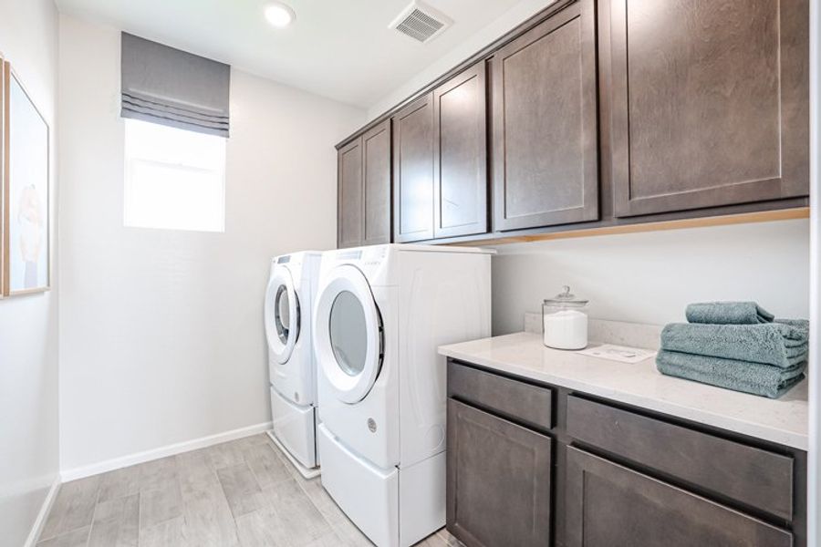 A laundry room with a washer and dryer. A laundry room with a washer and dryer.