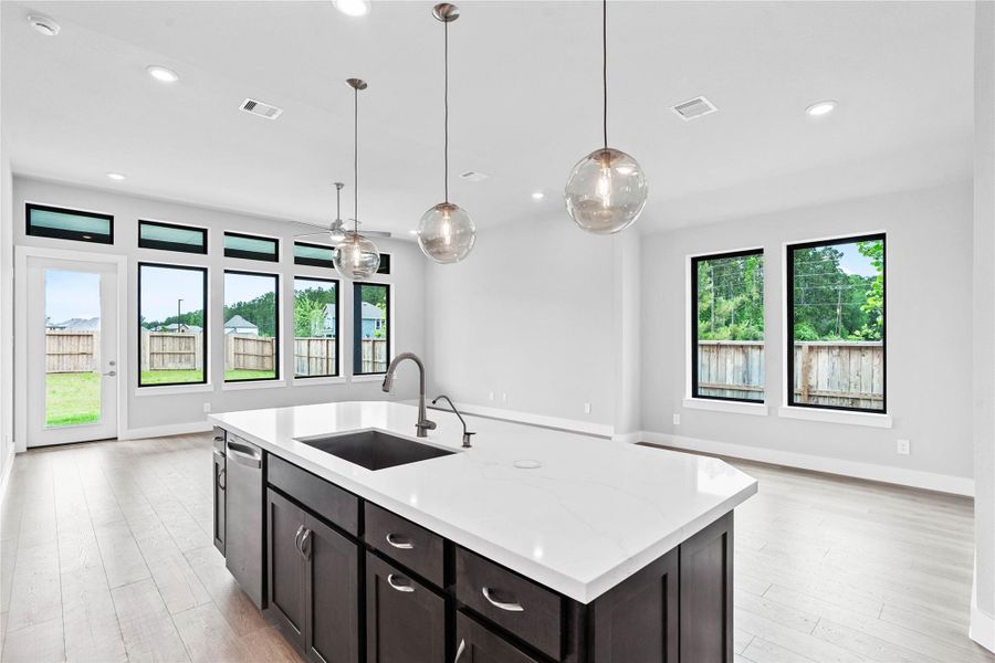 The intentional open design fosters a deep sense of connection between all three primary living zones. Sightlines remain clear from the sink to the sofa, promoting inclusive living and effortless entertaining.