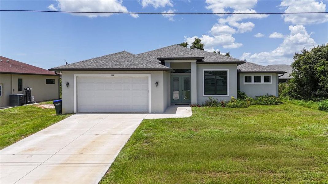 Front exterior of a new home in , North Port, FL, highlighting curb appeal (Image 1). Front exterior of a new home in , North Port, FL, highlighting curb appeal (Image 1).