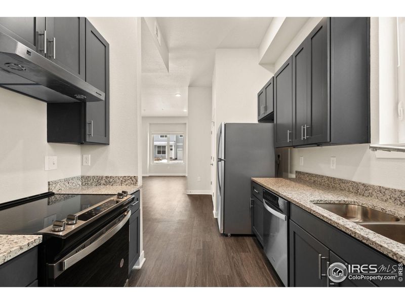 Kitchen with new cabinets, countertops and stainless steel appliances.