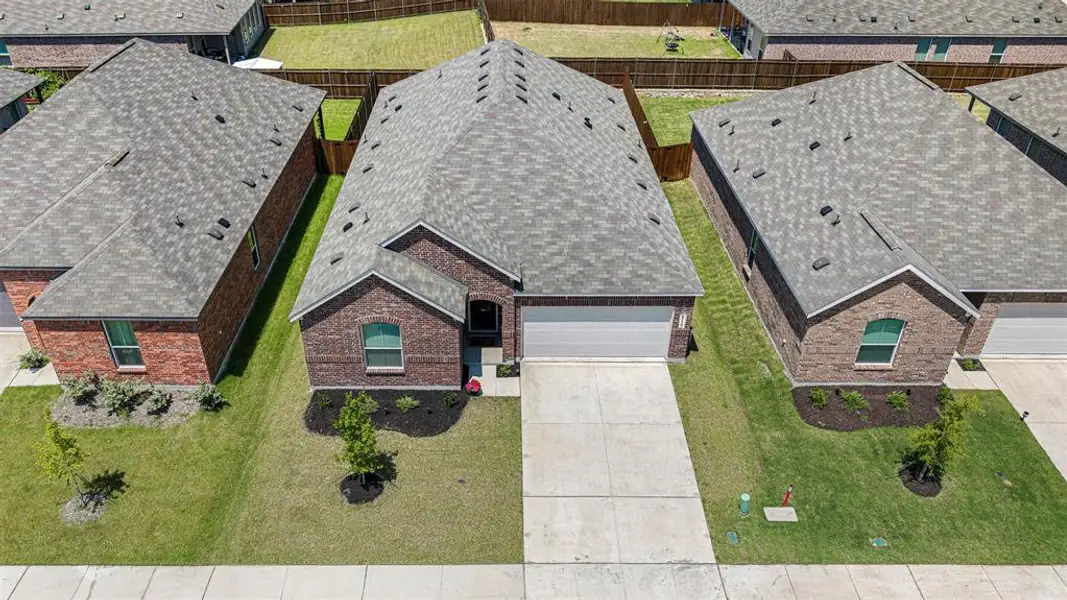 Brick facade home with an attached two-car garage, concrete driveway, and a shingle roof Brick facade home with an attached two-car garage, concrete driveway, and a shingle roof