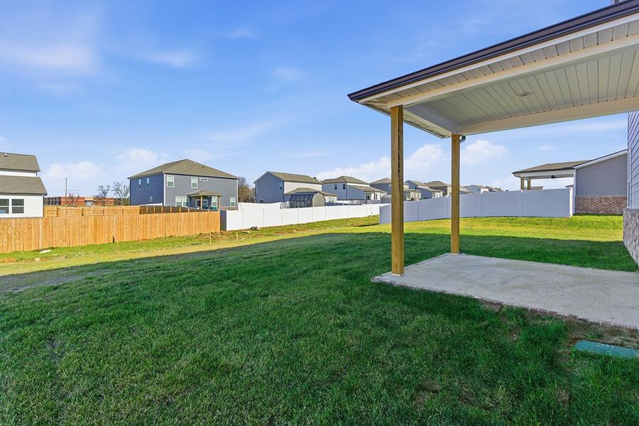A backyard with a covered area.