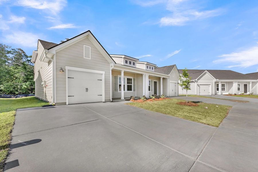 Front exterior of a new home in Tea Farm, Ravenel, SC, highlighting curb appeal (Image 2). Front exterior of a new home in Tea Farm, Ravenel, SC, highlighting curb appeal (Image 2).