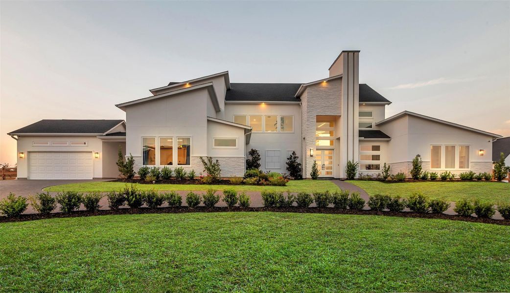 Front Elevation:Arrive in elegance as the modern façade commands attention with architectural precision. The soaring entry tower and glass French doors set the tone for distinction, while the sweeping U-shaped drive and manicured grounds frame a residence of undeniable prestige.