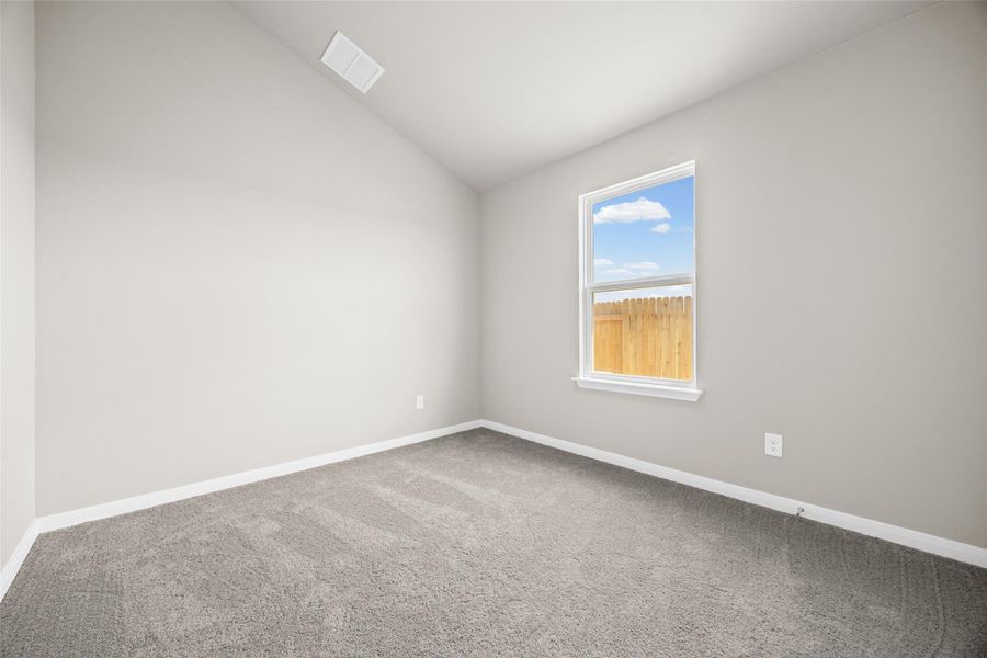 Vaulted ceilings and plush carpeting define this versatile secondary bedroom space. Vaulted ceilings and plush carpeting define this versatile secondary bedroom space.