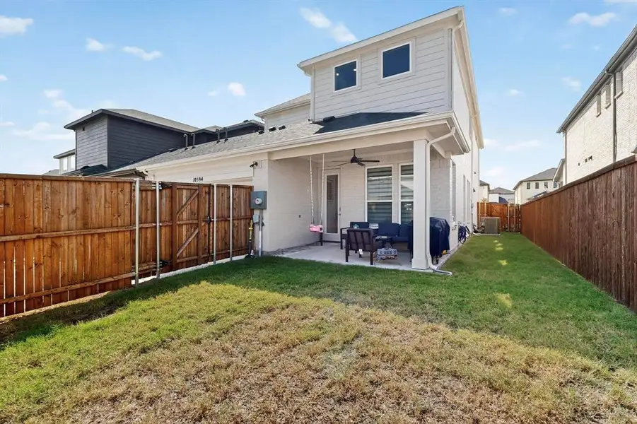 Back of property with a patio area, ceiling fan, brick siding, a gate, and a fenced backyard Back of property with a patio area, ceiling fan, brick siding, a gate, and a fenced backyard