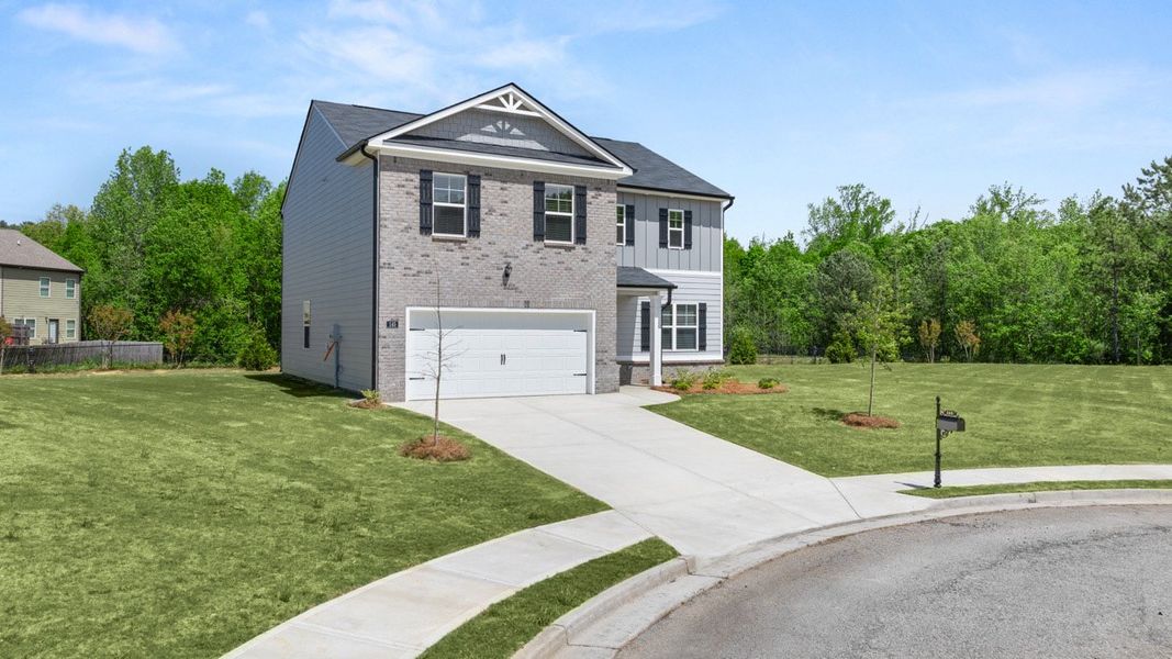Front exterior of a new home in Locust Grove Station - Cedar Ridge, Locust Grove, GA, highlighting curb appeal (Image 18). Front exterior of a new home in Locust Grove Station - Cedar Ridge, Locust Grove, GA, highlighting curb appeal (Image 18).